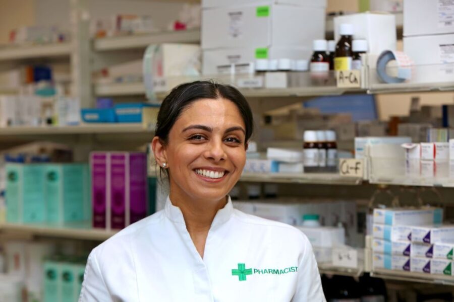 Female pharmacist standing in front of medications