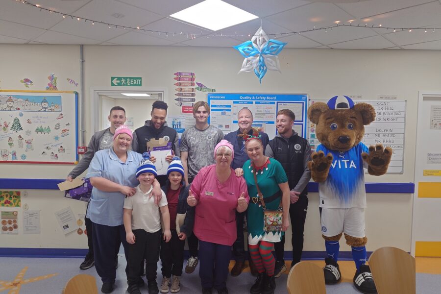 Stockport County members and mascot at the Treehouse children's unit at Christmas