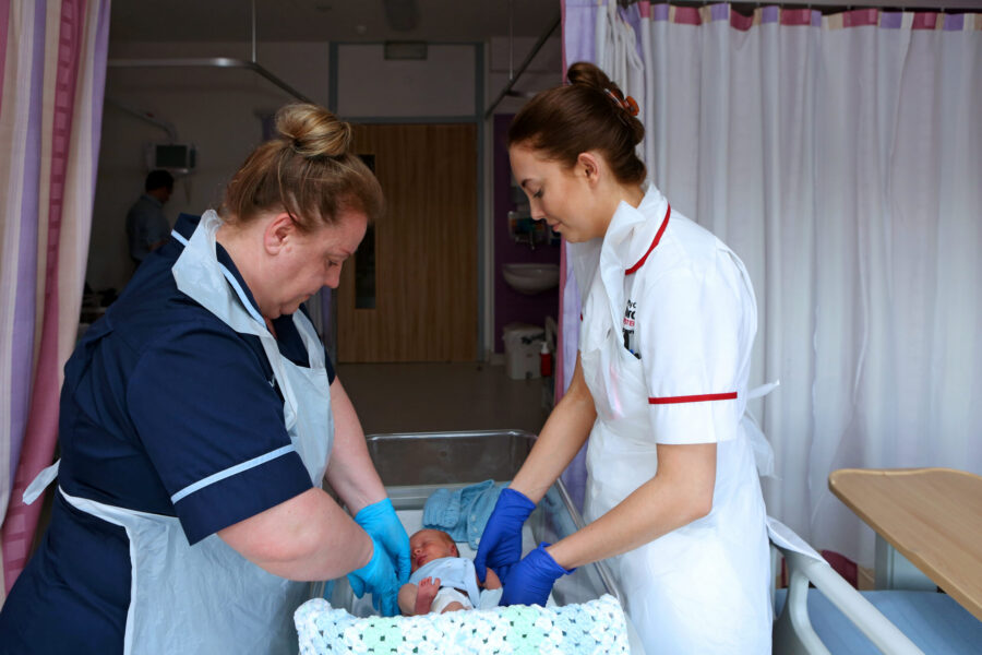 Midwives with baby