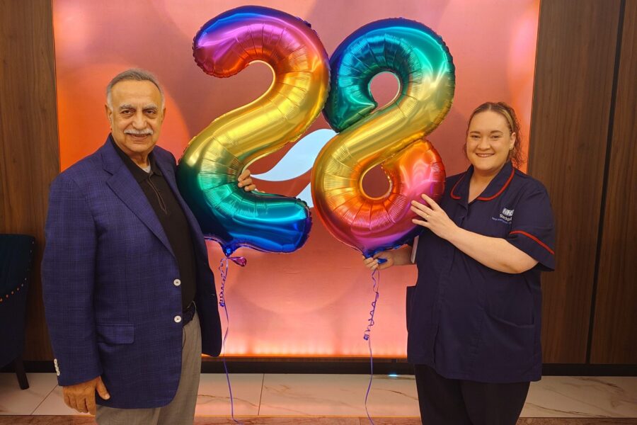 Mahboob Hussain and matron Helen Large with '2' and '8' balloons
